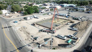 Drone shot of the Les Schwab Grand Junction construction site featuring an active concrete pour.